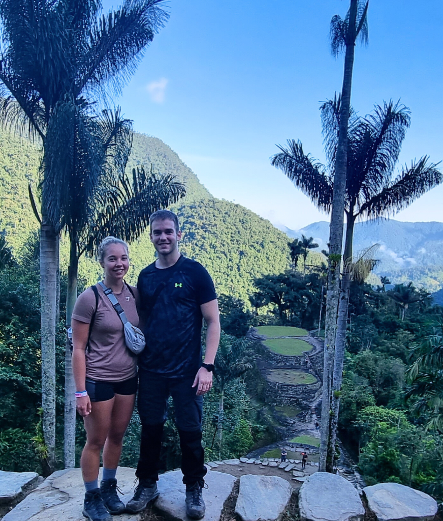 A photo of us with the ancient ruins of the Lost City in the background, nestled deep in the Sierra Nevada jungle of Colombia.