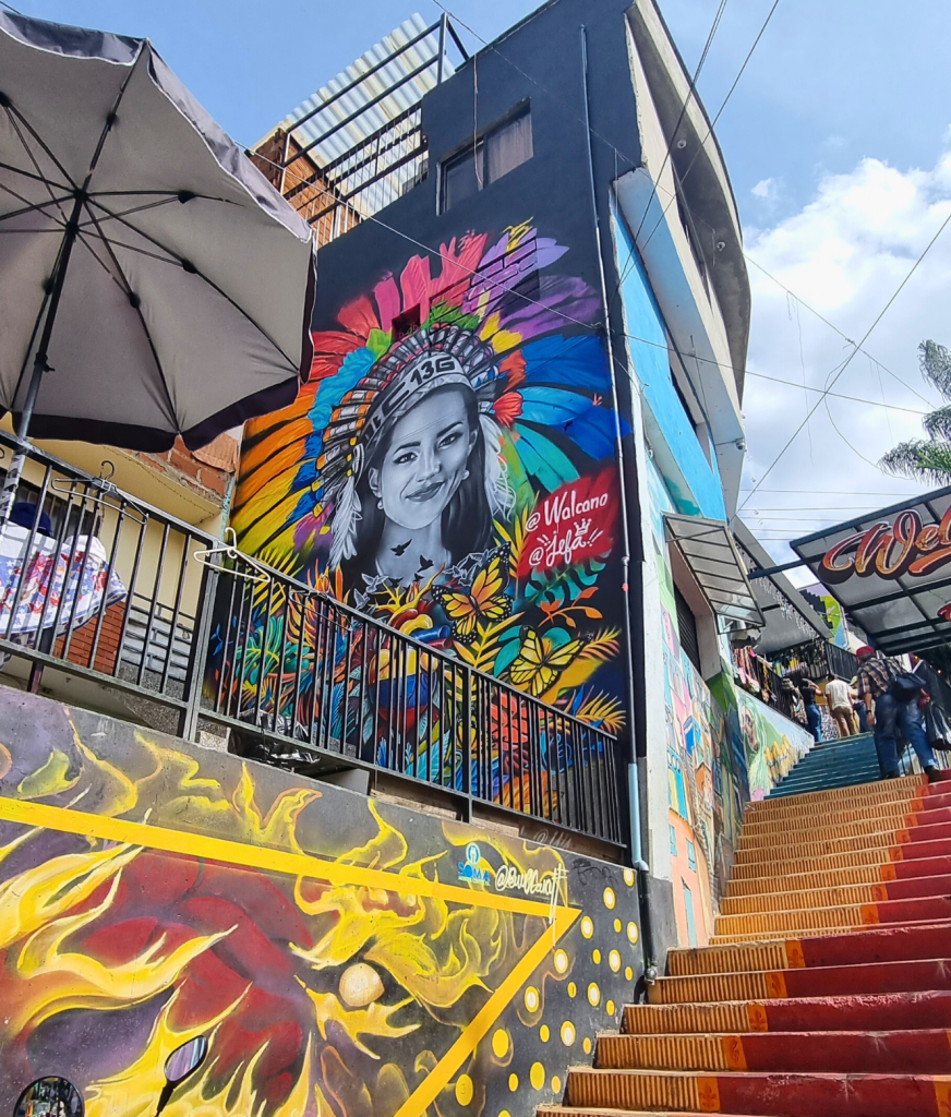 Vibrant street art in Comuna 13, Medellín, showcasing large-scale murals that celebrate the neighborhood’s culture and history.