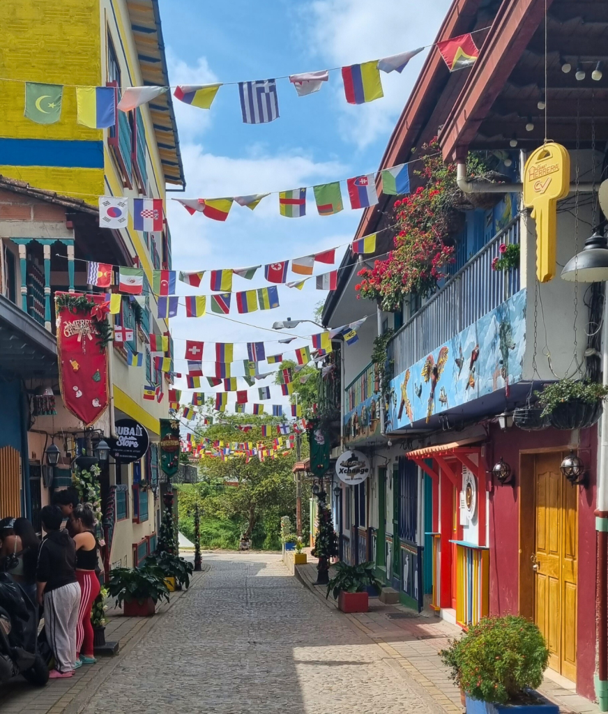 Charming cobblestone street in Guatapé, Colombia, lined with colorful buildings and vibrant doors, capturing the town’s colorful spirit.