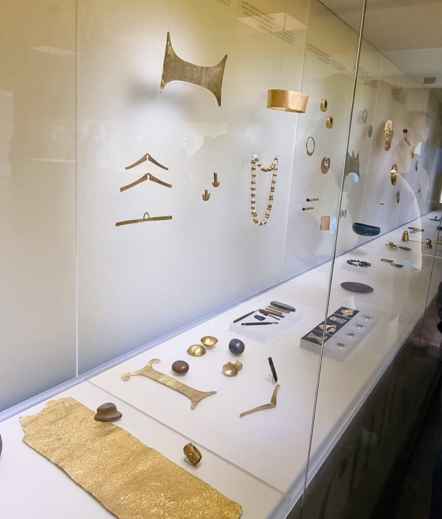 Inside the Gold Museum in Bogotá, showcasing ancient gold artifacts from Colombia's indigenous cultures under soft lighting.